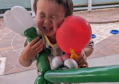 balloon twisting, excited child, day care opening