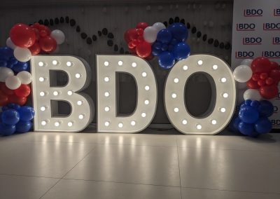 organic balloon arch on light up letters
